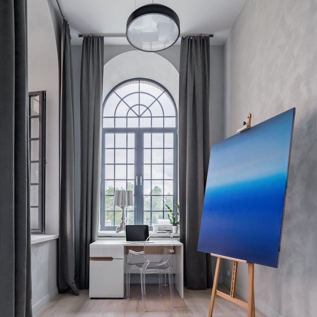 Luxury home office with high ceiling and plexiglass chair