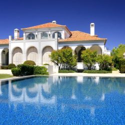 Modern luxurious home with a big pool in the foreground